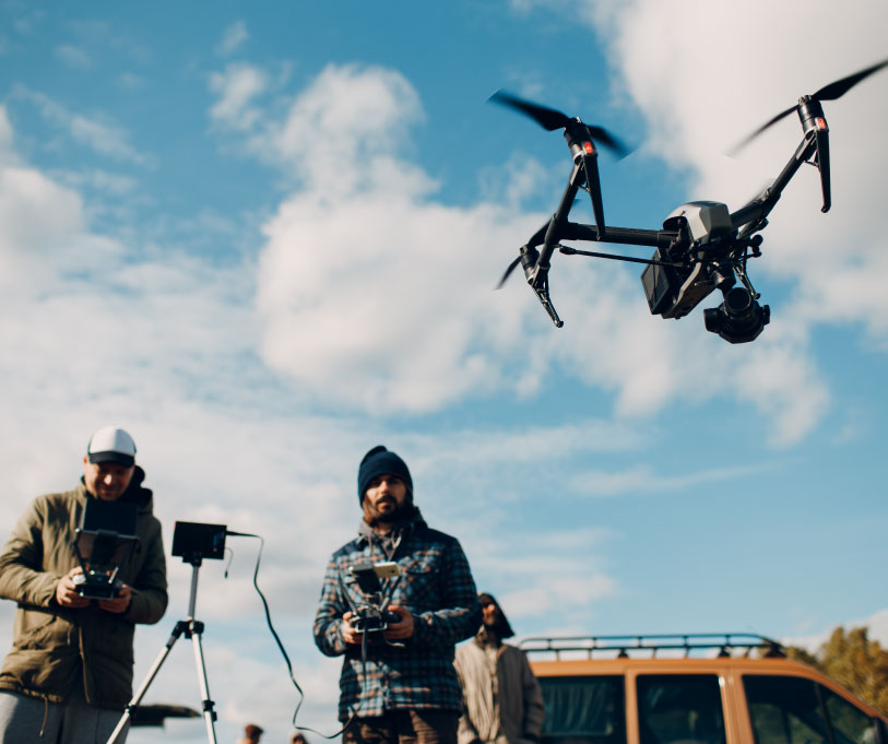 Drone team capturing roof data outdoors