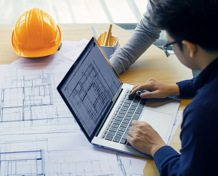 Engineer reviewing digital plans Southern UK